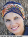 Turbante Cap Lilly di Gisela Mayer tinta unita, fascia colorata a parte, per perdita di capelli dovuta ad alopecia o tumore